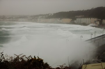 A Super storm lashes the coast at the Promenade of Douglas on the Isle of Man with monster waves rolling in off the turbulent Irish Sea
