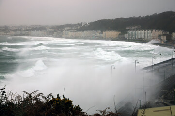 A Super storm lashes the coast at the Promenade of Douglas on the Isle of Man with monster waves rolling in off the turbulent Irish Sea