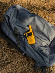 a yellow radio station with a digital display on it is laying on a bag.