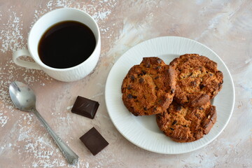 a plate of chocolate cookies and a cup of strong coffee