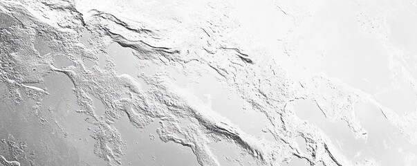 Fototapeta premium A textured surface resembling abstract natural formations, showcasing a variety of patterns in shades of gray and white.