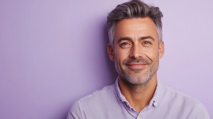 Fototapeta premium Confident man smiling against a purple background