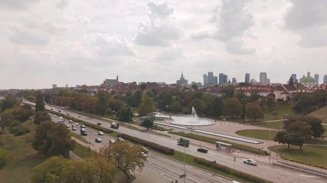 Stunning aerial view of Warsaw featuring a large fountain tree lined roads and a mix of historic and modern buildings Perfect for urban city life or architecture related content