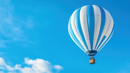 Fototapeta premium A vibrant hot air balloon rises gracefully against a bright blue sky, surrounded by fluffy white clouds, marking a perfect day for ballooning adventures