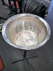 a bowl with chalk or talcum powder for athletes in the gym