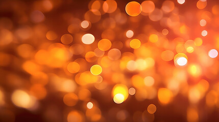 Fototapeta premium Blur bookeh gold lights or flashes on a dark orange color background