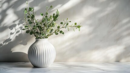 elegant white ceramic vase with lush greenery on sleek marble surface crisp shadows negative space minimalist composition ideal for interior design or lifestyle content