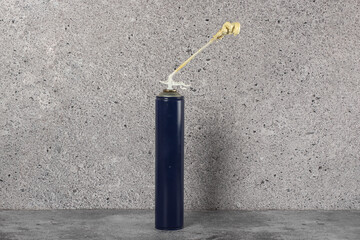A can of polyurethane foam near the wall.