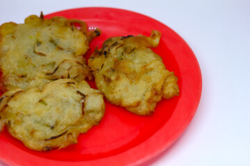 fried bakwan food served on a red plate