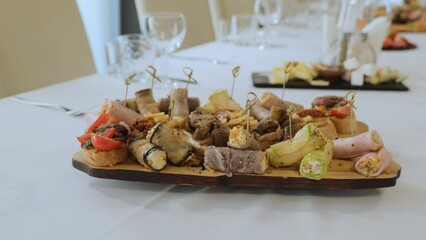 A beautiful festive table covered with a variety of food. Food and drinks on the festive table in the restaurant on birthdays, weddings. Beautifully decorated banquet table with appetizers.