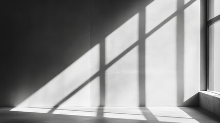 Obraz premium A close-up view highlights soft light cascading through a minimalist window, casting long shadows on a neutral wall, evoking a tranquil atmosphere