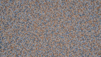 Rough gravel texture with small gray and brown stones for outdoor or industrial use