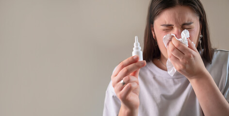 Woman sneezing while covering her nose with a tissue, showcasing an allergic reaction.