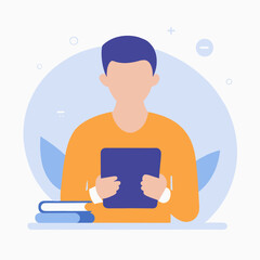 A man in an orange shirt is reading a book. Concept of relaxation and leisure, as the man is sitting at a desk with a book in his hand