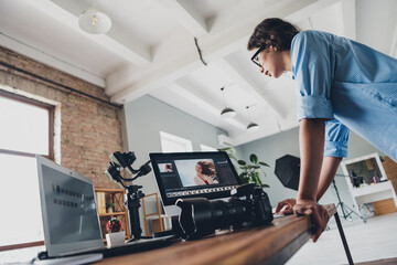 Photo of adorable positive lady professional wear shirt choosing photo modern gadget indoors workplace workshop