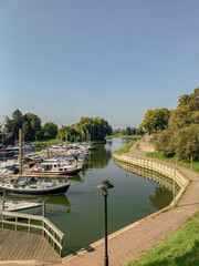 Fototapeta premium Boats and yachts on the embankment of the canal