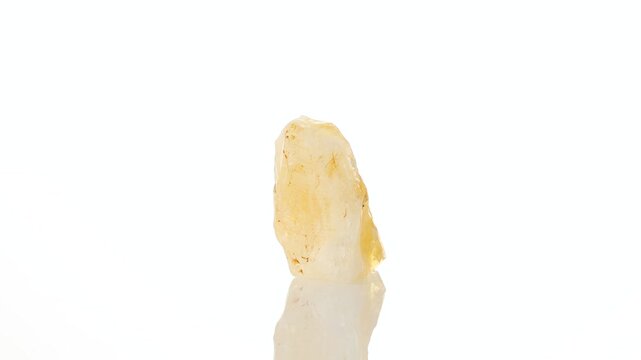 mineral stone citrine rotates in a circle on a white background