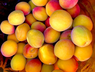 Fresh ripe apricots in a basket, closeup of photo