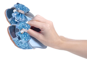 Festive Blue Baby Shoes in hand on white background isolation