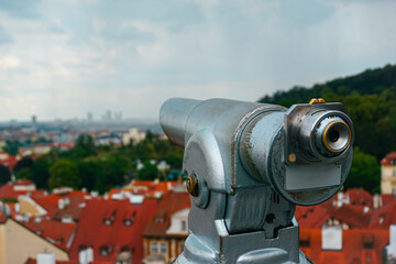 Public telescope with city in background