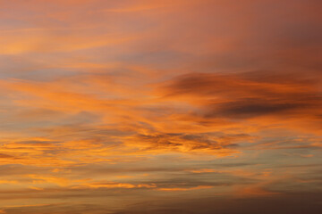 Beautiful and intense orange clouds filling the sky during a breathtaking sunset, creating a captivating natural spectacle