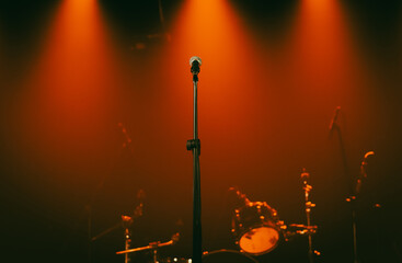Background - microphone on stage against red spotlights, no people