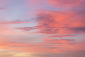 The sky at sunset is a breathtaking blend of pink, orange, blue, red, purple, and yellow clouds, creating a serene and tranquil backdrop for any project