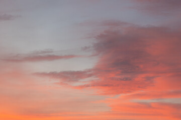 Colorful sunset sky with abstract cloud shapes in orange and purple hues, creating a dramatic and serene atmosphere