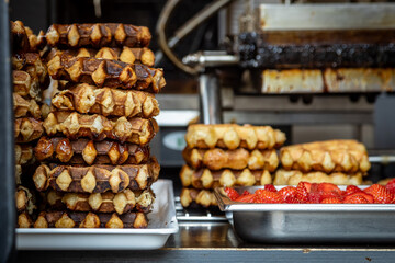A pile of Belgian waffles for sale in the city of Ghent, with a shallow depth of field