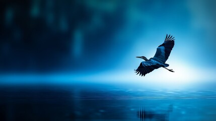 Fototapeta premium A bird soaring above tranquil water, backdrop of azure sky, tree in the foreground