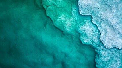 Fototapeta premium A bird's-eye perspective of a frozen body of water with an incoming wave