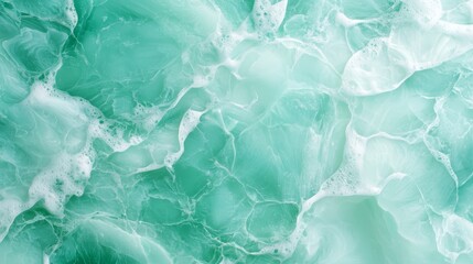 Fototapeta premium A tight shot of a green-white marbled wallpaper, adorned with white whorls at its upper and lower edges