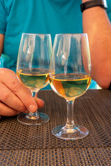 Obraz premium Tasting of Bordeaux white wine in Sauternes, left bank of Gironde Estuary, France. Glasses of white sweet French wine served in restaurant