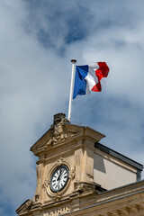 Blue red white french flag on roof of ciry hall in France