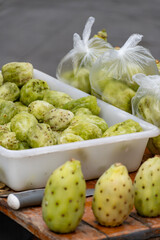 Ripe juicy edible fruits opuntia prickly pears cacti for sale on Triana farmer market in Sevilla, Andalusia, Spain