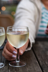 Tasting of Bordeaux white wine, right bank of Gironde Estuary, France. Glasses of white sweet French wine served in outdoor restaurant