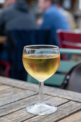 Tasting of Bordeaux white wine, right bank of Gironde Estuary, France. Glasses of white sweet French wine served in outdoor restaurant on oysters farm in Gujan-Mestras, Arcachon bay