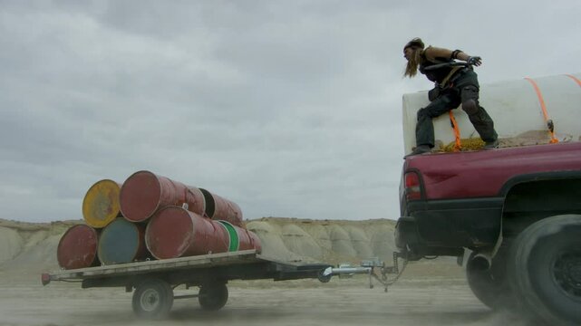 Epic stunt woman jumps onto moving platform and releasing large barrels 