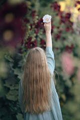 A girl in the mallow flower garden