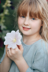 A girl in the mallow flower garden