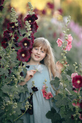 A girl in the mallow flower garden