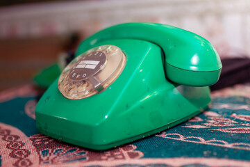 An Artistic Representation of a Retro Green Rotary Telephone on Beautiful Vintage Fabric