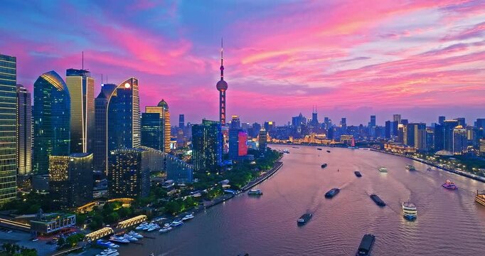 Aerial shot of modern city buildings skyline and river at sunset in Shanghai