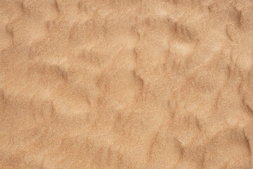 The undulating texture of sand on the seashore