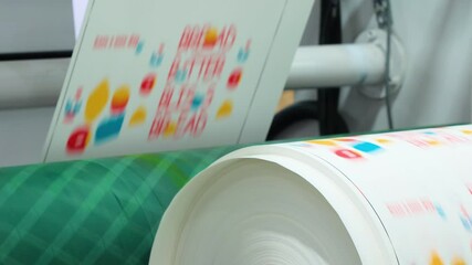 Automatic polyethylene plastic bag production machine with lighting effect. Close-up of the roller of the plastic bag production machine in the light. product packaging concept