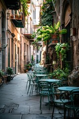 A narrow alleyway with tables and chairs lined up, perfect for outdoor events or markets