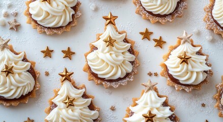 Festive mini dessert trees decorated with golden stars on a white table with pinecones