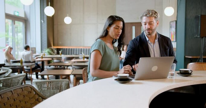 Business People Meeting in Restaurant and work on Laptop