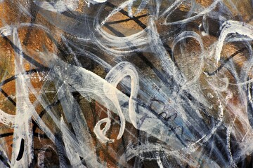 Abstract artwork featuring swirling lines and textures in earthy tones.