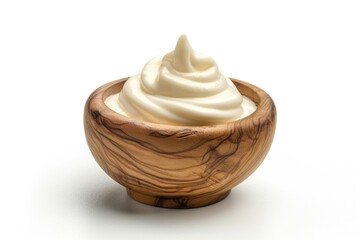 A wooden bowl filled with whipped cream on a white surface, perfect for desserts or presentation